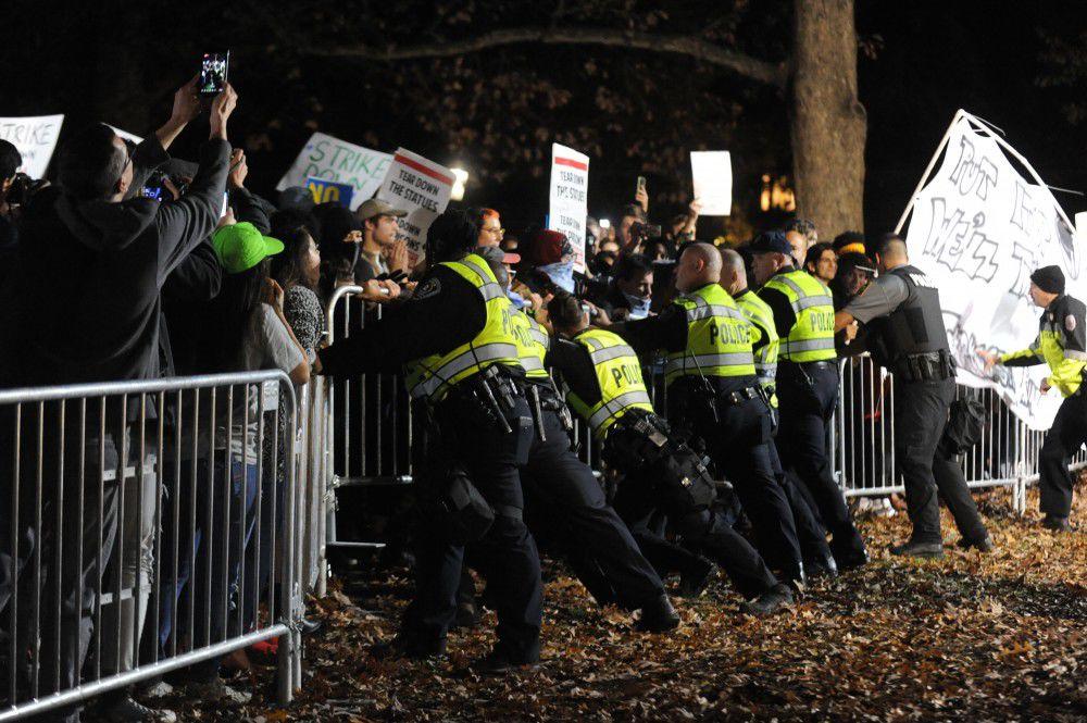 Police respond to Silent Sam protest on Monday, Dec. 3.
