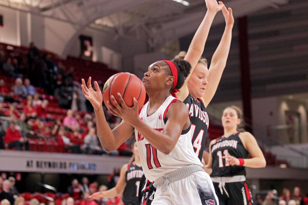 Graduate guard Kiara Leslie attacks the basket against Davidson guard Cassidy Gould on Sunday, Dec. 30 at Reynolds Coliseum. Leslie recorded 13 points and seven rebounds in the Wolfpack's 75-45 win.