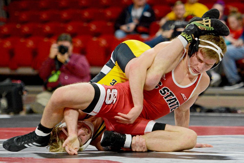 NC State's Thomas Bullard fights against Appalachian State's Michael Elliott at Reynolds Coliseum on Dec. 4, 2018. The Wolfpack won 29-9 over App State.