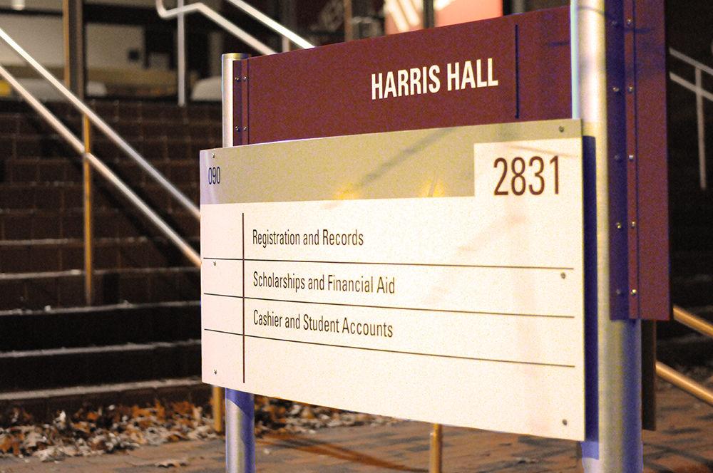 A sign stands outside Harris Hall, indicating the contents of the building on Wednesday. Harris Hall is home to the offices of Registration and Records, Scholarship and Financial Aid, and Cashier and Student Accounts.