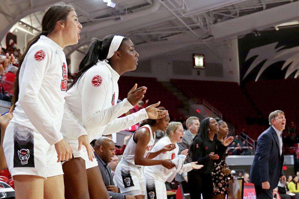 The NC State bench celebrates after a 3-point play against Michigan in Reynolds Coliseum on Thursday, Nov. 29. The Wolfpack had 36 points in the paint on their way to a 66-55 win.