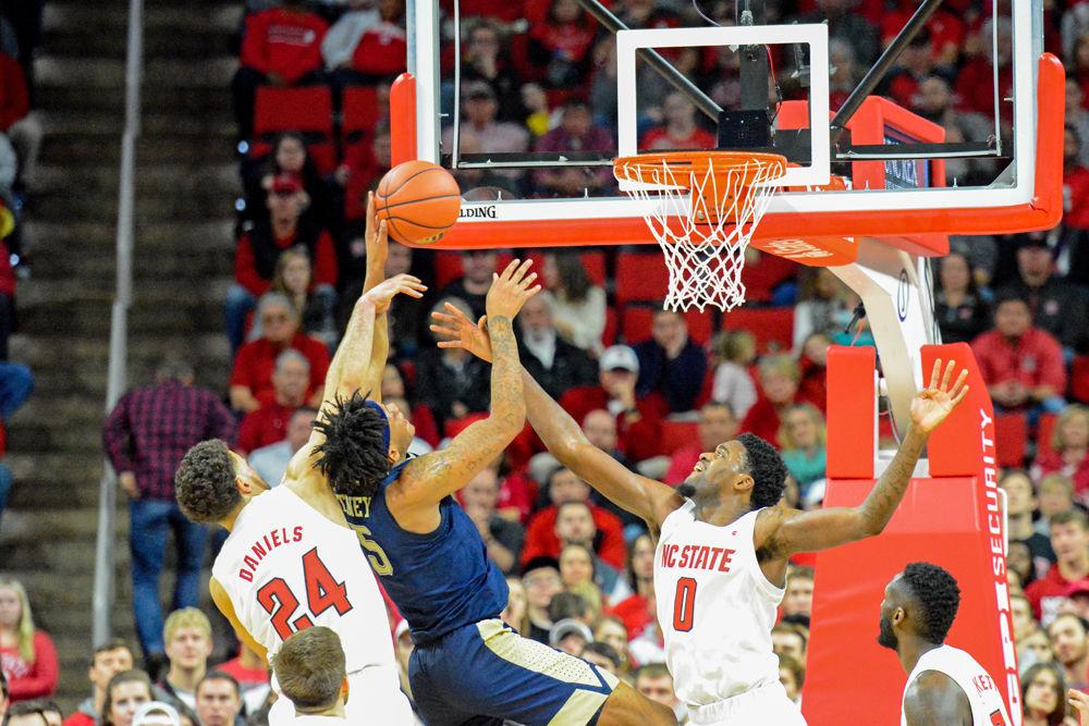 Redshirt sophomore guard Devon Daniels and redshirt sophomore forward DJ Funderburk fight for an offensive rebound against Pittsburgh guard Au&#8217;Diese Toney on Saturday, Jan. 12 at PNC Arena. Daniels had 19 points and Funderburk scored 18 points as NC State won 86-80.