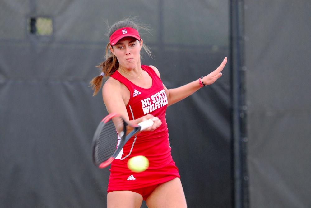Freshman Adriana Reami returns a ball to Clemson opponent Fernanda Navarro at J.W. Isenhour Tennis Center on Friday, March 31, 2017. Reami won her match against opponent Navarro after two sets, scoring 7-5 and 6-3, respectively. The Wolfpack beat Clemson 6-1.