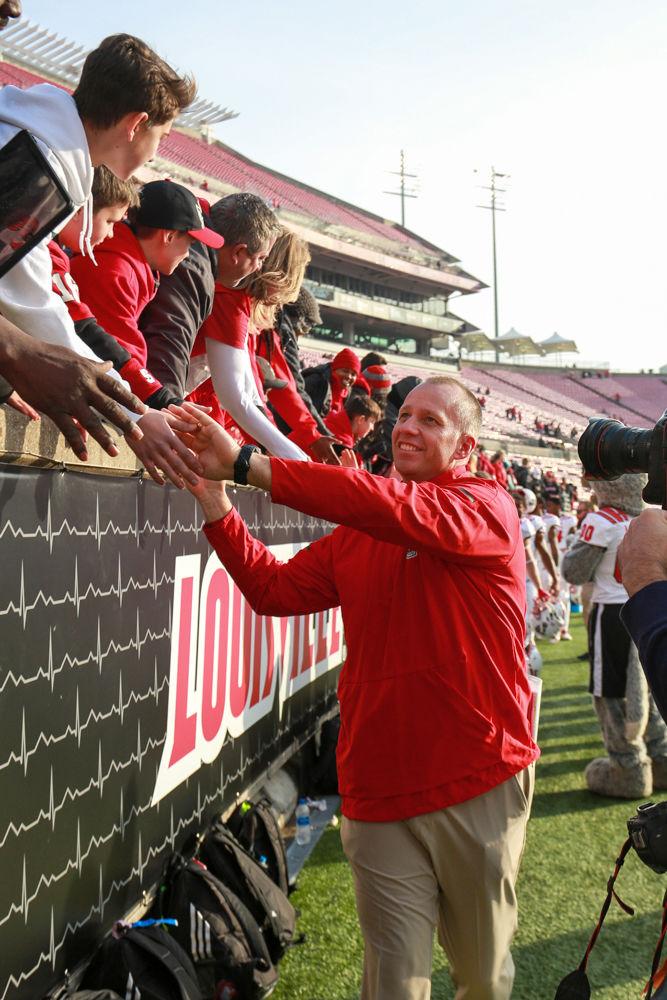 Head coach Dave Doeren&#160;takes time to high-five the fans after the 52-10 rout of Louisville on Nov. 17 in Cardinal Stadium.