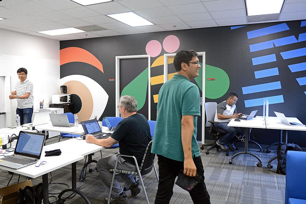 Various employees and NC State graduate students work together in the IBM Education Innovation Center on the third floor of Research IV on Centennial Campus on Wednesday, May 16, 2018. Andy Rindos, an IBM employee, said that the center works to facilitate collaborative meetings and the company's existing partnership with NC State. In the fall of 2018, NC State gained access to a quantum computing network through IBM Q..