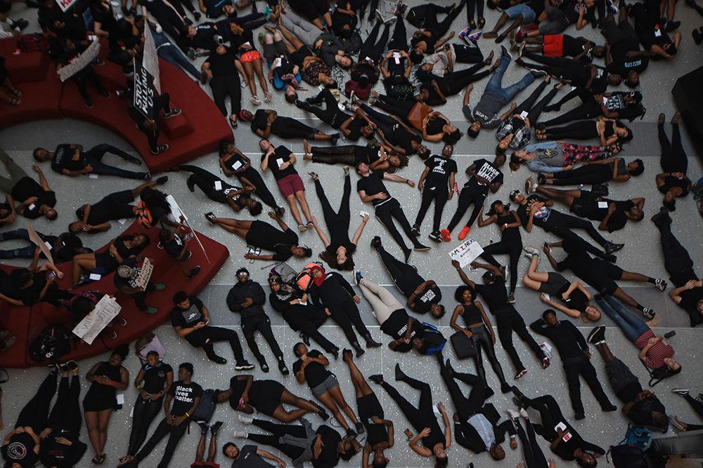 NC State students fill the Talley Student Union atrium on Sept. 23, 2016 for a "die-in" as a form of nonviolent protesting. Students laid down and filled the floor to represent those who have been unfairly murdered.