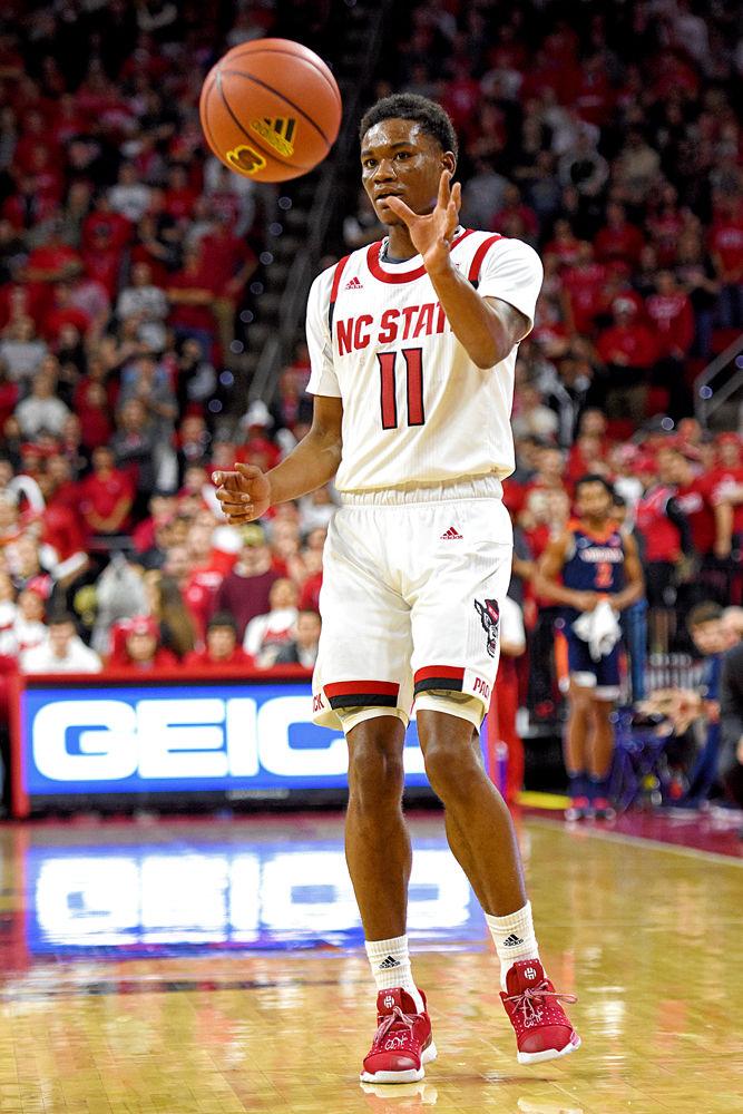 Junior guard Markell Johnson reaches for the ball at PNC Arena on Tuesday, Jan. 29. Johnson recorded 14 points and six rebounds in the Wolfpack's 66-65 overtime loss to Virginia.