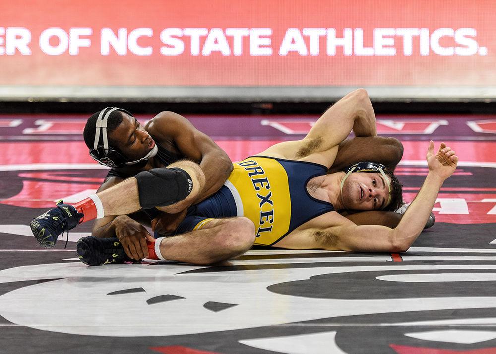 Redshirt Senior No. 20 Malik McDonald, in the 197 weight class, takes down Derek Rose from Drexel University on Saturday, Jan. 19 at Reynolds Coliseum. The Wolfpack beat Drexel 25-16.