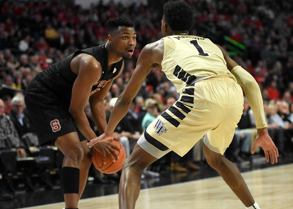 Redshirt senior guard Torin Dorn attempts to get past Wake Forest during the game on Tuesday, Jan. 15 in Lawrence Joel Veterans Memorial Coliseum. Despite Dorn scoring 18 points, the Wolfpack still lost to the Demon Deacons 71-67.