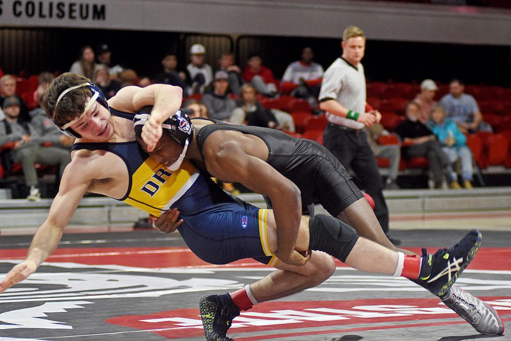 Redshirt senior Jamel Morris wrestles Drexel junior Nick Widmann during the dual on Saturday, Jan. 19, 2019 at Reynolds Coliseum. The Wolfpack beat the Dragons 25-16.