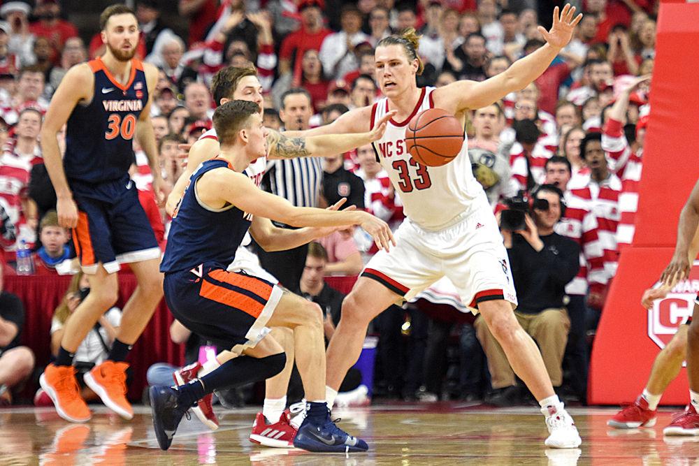 Graduate forward Wyatt Walker defends Virginia guard Kyle Guy at PNC Arena on Tuesday, Jan. 29, 2019. Walker recorded 11 points, seven rebounds and three blocks as the Wolfpack lost 66-65 in overtime.