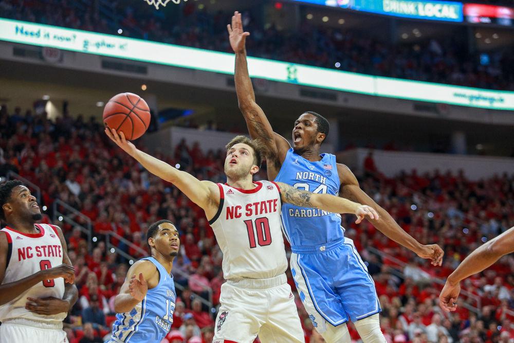 Sophomore guard Braxton Beverly slashes by UNC-Chapel Hill guard Kenny Williams for a layup on Tuesday, Jan. 8 at PNC Arena. Beverly was the only reliable three-point shooter going 5-7 while the rest of the team tallied 3-21. The Wolfpack was able to cause 23 turnovers, but could not overcome the poor shooting to fall 90-82.
