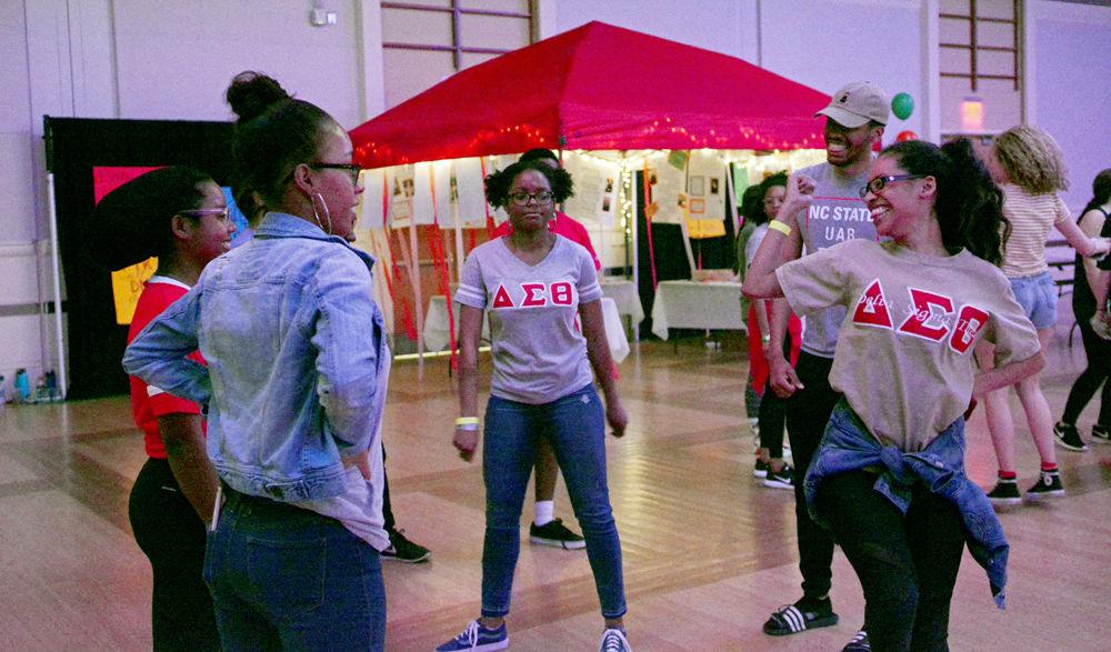 Members of Delta Sigma Theta Sorority, Inc. dance with friends during a dance marathon in the State Ballroom in Talley Student Union on Saturday, Feb. 24, 2018. Dance Marathon at NC State is an annual 12-hour event in which participants raise money for children through the Children's Miracle Network. The proceeds collected by the dancers went toward Duke Children's Hospital.
