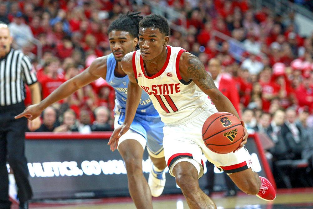 Junior guard Markell Johnson flies past UNC-CH guard Coby White. Johnson had 11 points and four steals during the 90-82 loss to UNC on Tuesday, Jan. 8 in PNC Arena.