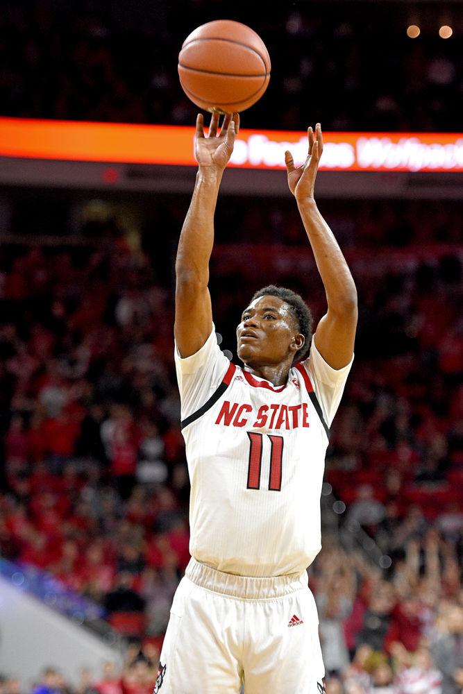 Junior guard Markell Johnson attempts a 3-point shot against Virginia at PNC Arena on Tuesday, Jan. 29. Johnson recorded 14 points and six rebounds in the Wolfpack's 66-65 overtime loss.