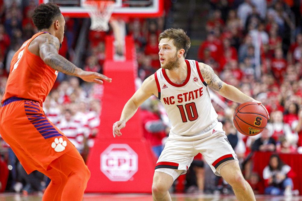 Sophomore guard Braxton Beverly makes a move against Clemson guard Marcquise Reed in PNC Arena on Saturday, Jan. 26. In addition to totaling five assists, he hit the game-winning 3-pointer at the buzzer after going 0-4 from three-point range to be the hero of the 69-67 win.