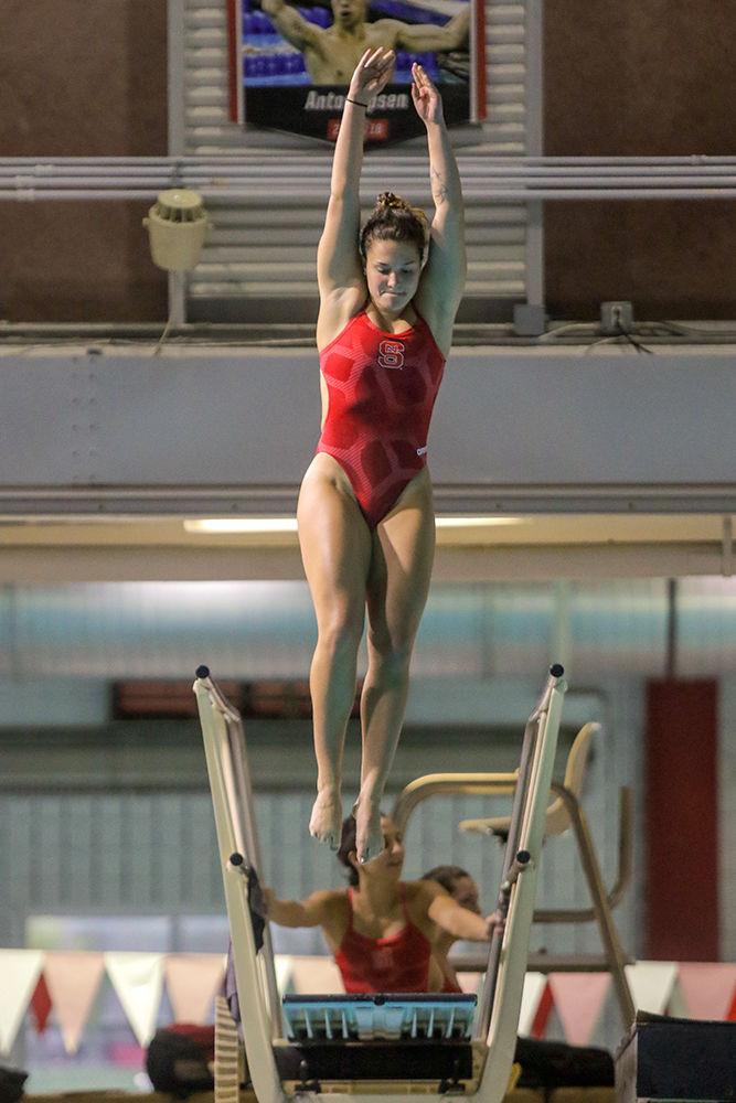 Junior diver Madeline Kline takes to the air in the diving circus during the fourth annual Wolfpack Games held on Friday, Sept. 28 In the Casey Aquatic Center.