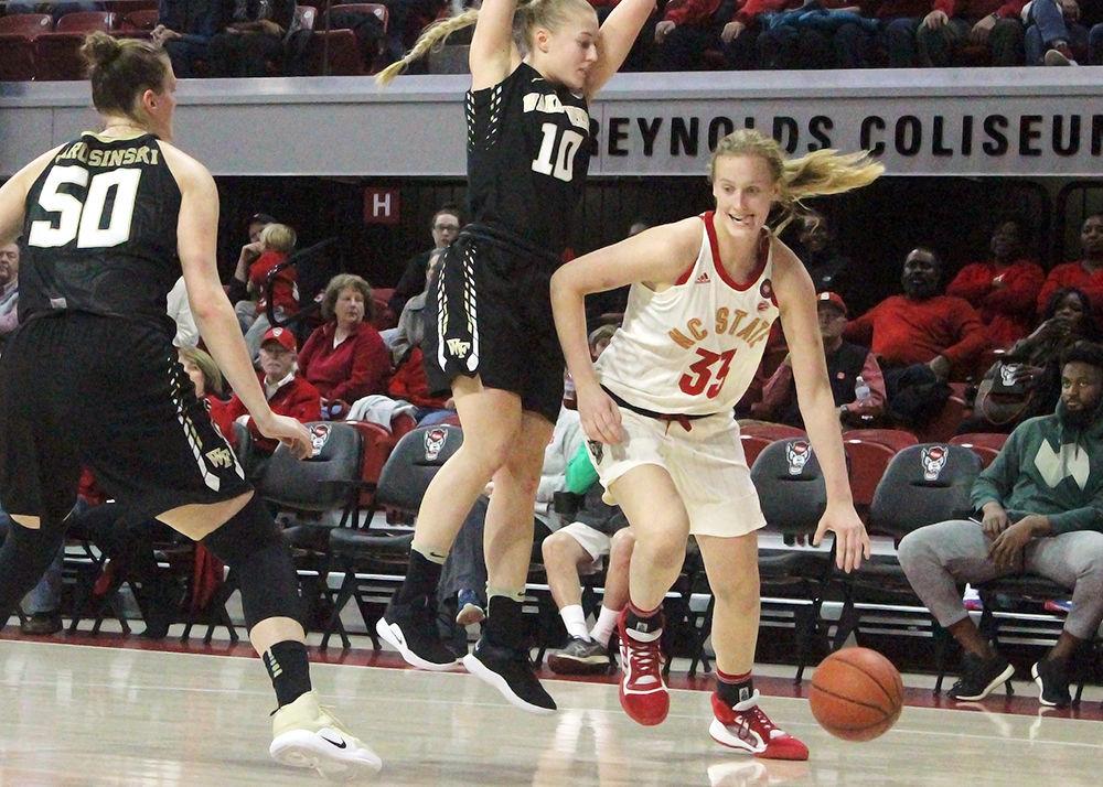 Freshmen center Elissa Cunane, gets past Wake Forest's freshman guard Ellen Hahne, and freshman forward Lindsey Jarosinski, , at Reynolds Coliseum on Thursday, Feb 21, 2019.&#160;Wolfpack beat the Demon Deacons 80-46.