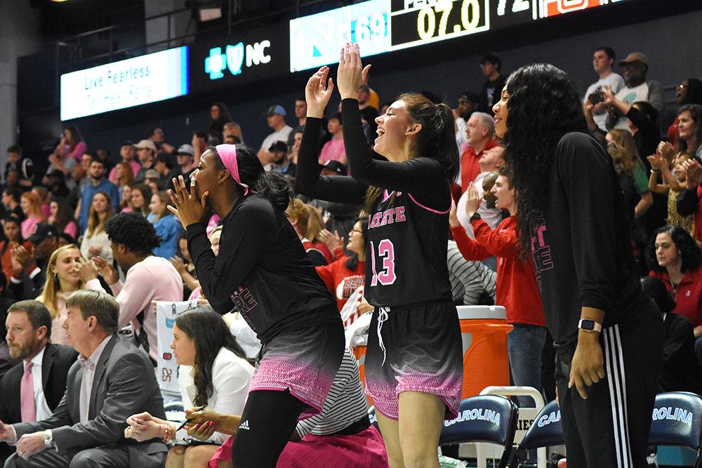 Freshman forward Jada Rice, freshman forward Esra McGoldrick, and junior forward Erika Cassell yell encouragement at their teammates during the final minutes of the game against UNC-Chapel Hill on Sunday, Feb. 24, 2019 in Carmichael Arena. The Wolfpack beat the Tarheels 74-69.