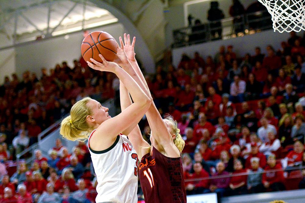 Freshman center Elissa Cunane shoots against Virginia Tech forward Regan Magarity on Sunday, Jan. 20 at Reynolds Coliseum. Cunane recorded six points and five rebounds in the Wolfpack&#8217;s 70-61 overtime win.