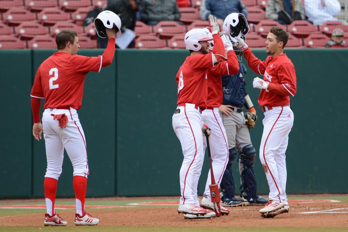 Junior infielder Will Wilson bumps helmets with his teammates after hitting a home run in the game versus Bucknell on Saturday, Feb. 16, 2019 at Doak Field. The Wolfpack beat the Bison 14-2.