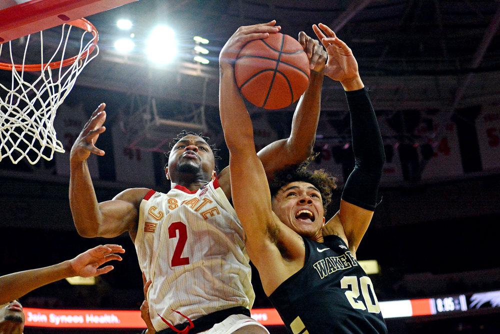 Redshirt senior guard Torin Dorn fights for a rebound against Wake Forest guard Michael Wynn on Sunday, Feb. 24, 2019 at PNC Arena. Dorn recorded a double-double, scoring 13 points and grabbing 10 rebounds. The Wolfpack beat the Demon Deacons 94-74.