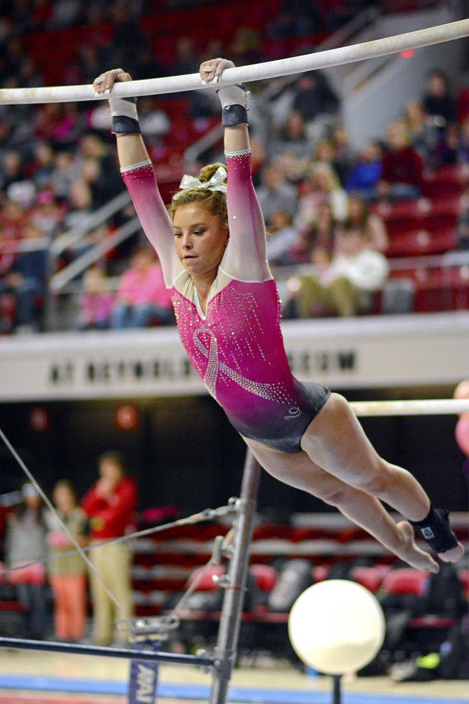 Sophomore Katie Cox performs on the uneven bars against Pitt on Saturday, Feb. 9 at Reynolds Coliseum. The Wolfpack defeated the Panthers 196.400 to 194.825.