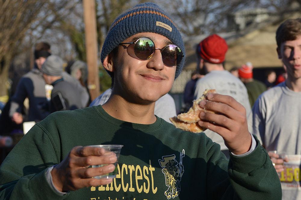Luis Garcia, a junior at Pinecrest High School, toasts to finishing his first half dozen donuts at the Krispy Kreme Challenge on Saturday, Feb. 2, 2019. Garcia traveled from Southern Pines, N.C. to participate in the race with his friends.
