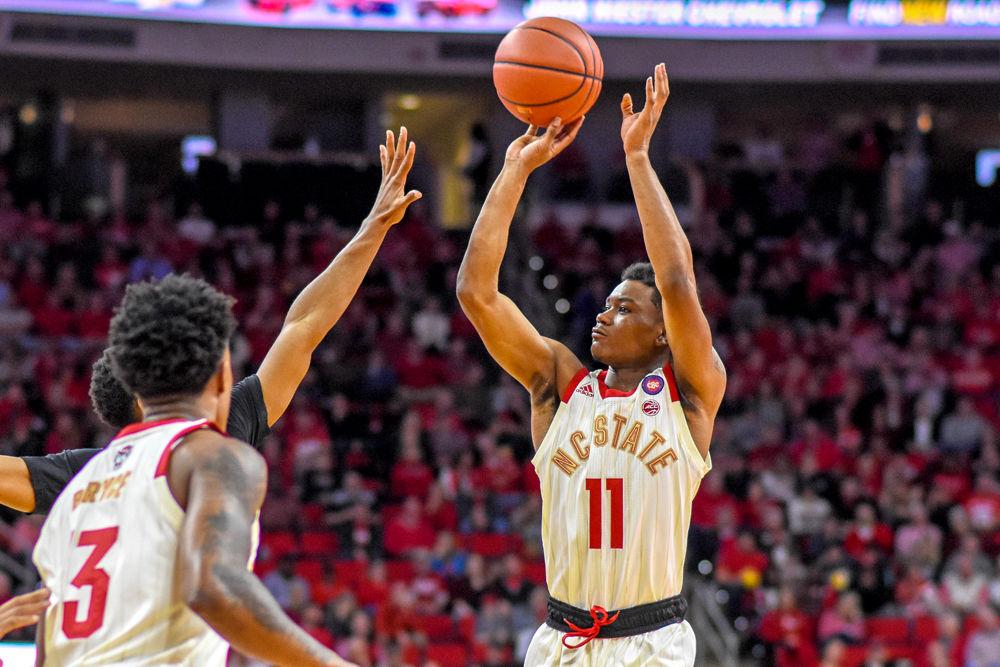 Junior guard Markell Johnson shoots a 3-pointer over the Wake Forest defense on Sunday, Feb. 24, 2019 in PNC Arena. Johnson scored 25 points and was the Wolfpack's top scorer against the Demon Deacons. The Wolfpack beat the Demon Deacons 94-74.