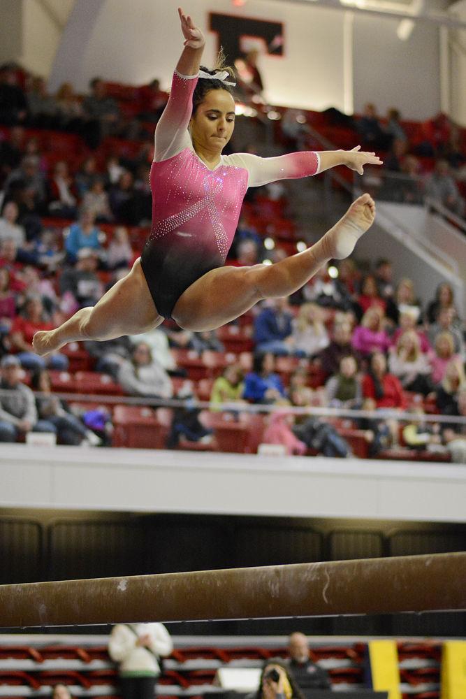 Junior Drew Grantham performs on the balance beam against Pittsburgh on Saturday, Feb. 9 at Reynolds Coliseum. Grantham placed last on the beam, but was second all around. The Wolfpack defeated the Panthers 196.400 to 194.825.