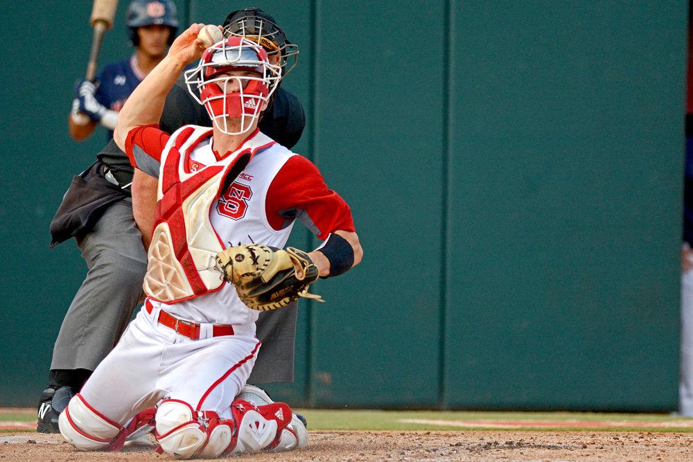 Freshman catcher Patrick Bailey attempts to throw an Auburn baserunner out at first base on Sunday, June 3, 2018 at Doak Field. Bailey went 3-5 with one double, two RBIs, two runs scored and two strikeouts as the Wolfpack lost 15-7.