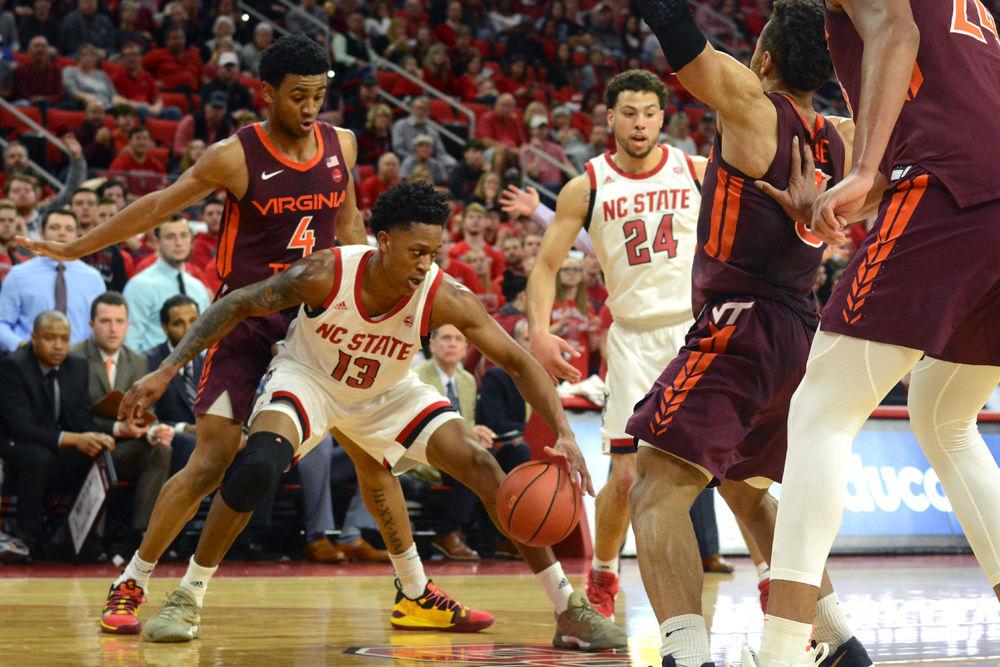 Redshirt junior C.J Bryce tries to get past a sea of Virginia Tech defenders on Saturday, Feb. 2 at PNC Arena. The Wolfpack lost 47-24.