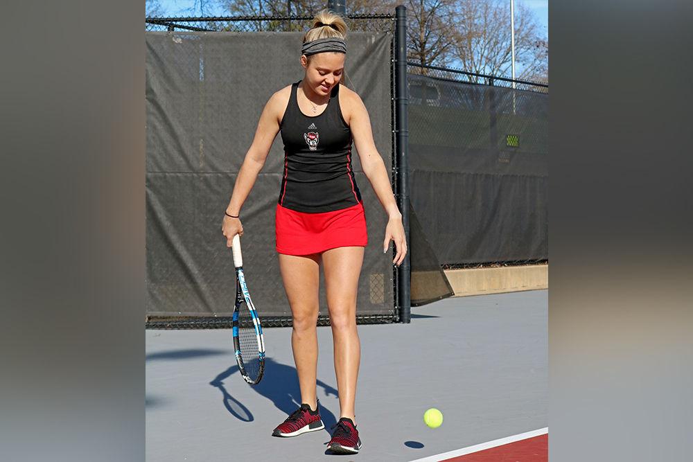 Senior Amanda Rebol prepares to serve at the J.W. Isenhour Tennis Center on Monday, Feb. 25, 2019. Rebol is ranked fifth for most NC State career singles wins at 61.