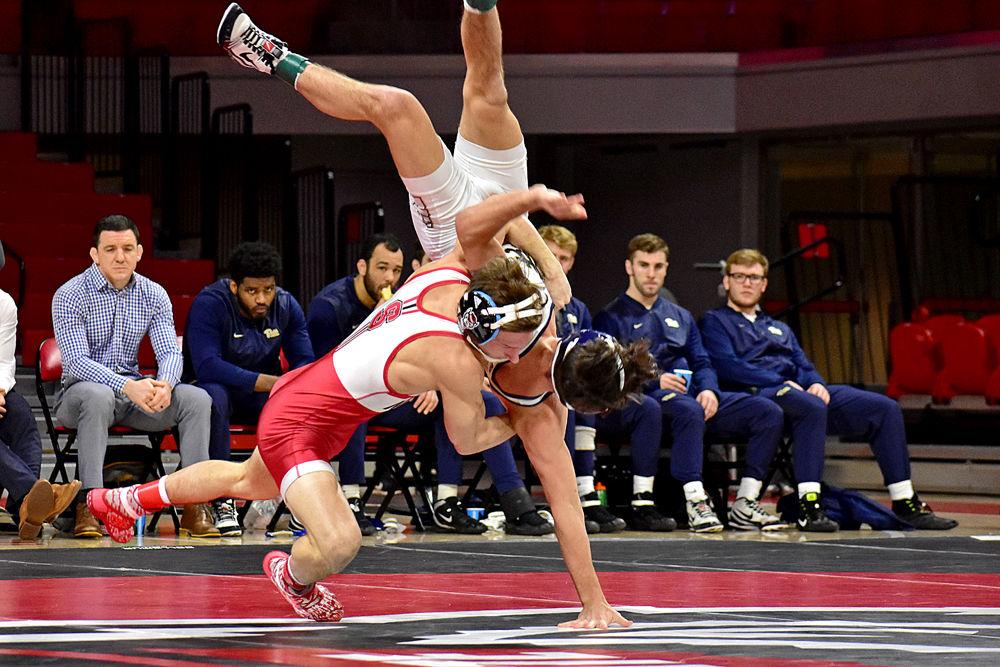 Redshirt freshman Zurich Storm takes down Pittsburgh freshman Brendon Fenton at Reynolds Coliseum on Sunday, Feb. 10. The Wolfpack lost 18-16 to Pittsburgh.