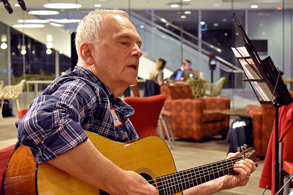 Derrell Posey plays the guitar with fellow bluegrass musicians at Wolfpack Pickers Jam in Talley Student Union on Monday, Feb. 18, 2019.