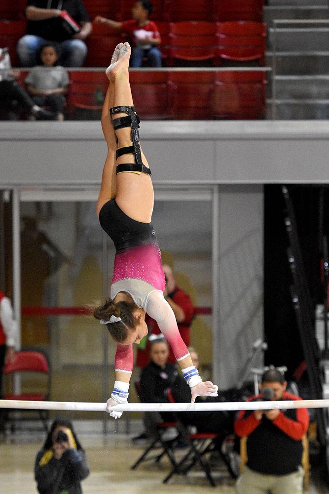 Maggie Tamburro, a senior in biomedical engineering, performs on the uneven bars against Pittsburgh at Reynolds Coliseum on Saturday, Feb. 9. The Wolfpack beat Pittsburgh 196.400 - 194.825 bringing their record to 5-2. Tamburro had an uneven bars score of 9.825.