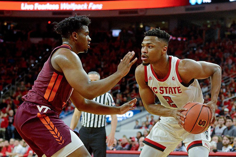 Redshirt senior guard Torin Dorn tries to get past Virginia Tech guard Isaiah Wilkins Saturday, Feb. 2 at PNC Arena. The Wolfpack lost 47-24.