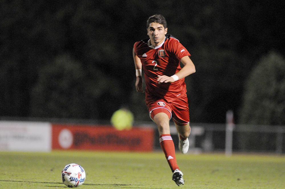 Freshman forward Manny Perez pushes the ball forward at the N.C. State V. Boston College men's soccer game in Dail Soccer Stadium on Friday, Oct. 27. The two teams tied with a score of 0-0 after two ten minute over time sessions.