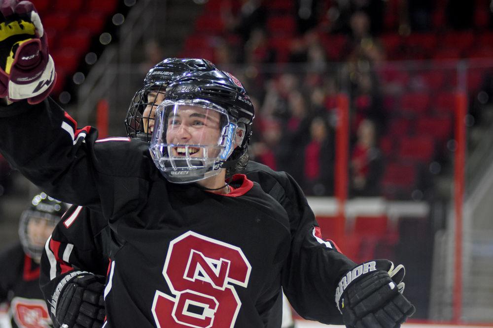 Riley Johnson, a first-year studying biology, and Alex Robinson, a first-year studying mechanical engineering, celebrate Johnson's goal at the annual Backyard Brawl on Monday, Oct. 22 at PNC arena. The Icepack beat UNC-Chapel Hill 9-5.