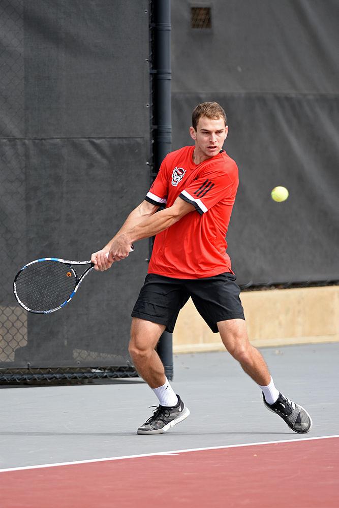 Freshman Yannai Barkai, playing third seed in singles against South Carolina, prepares to return a ball with his backhand on Saturday, Feb. 9 at the J.W. Isenhour Tennis Center. Barkai earned the Wolfpack's only point scored against the Gamecocks on Saturday, resulting in a loss with an overall score of 6-1.