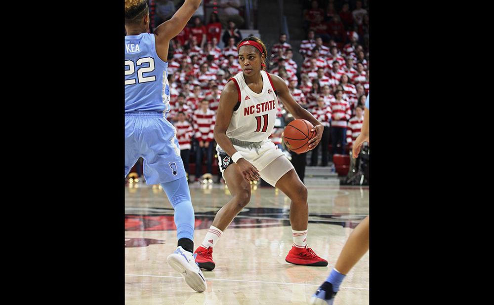 Graduate guard Kiara Leslie looks for an opening while playing offense against UNC-Chapel Hill guard Paris Kea. The NC State women's basketball team lost 64-51 to UNC-CH on Feb. 3 at Reynolds Coliseum.