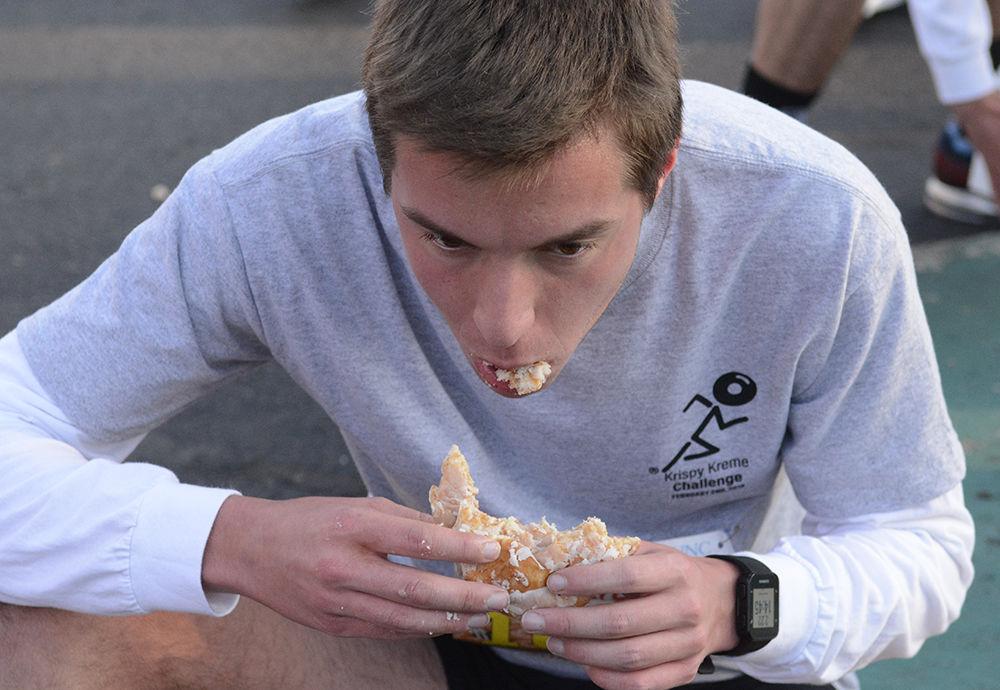 Challenger Colton Strandberg, a 19-year old from Greensboro, North Carolina, tries not to vomit up his dozen doughnuts as he competes in the 15th annual Krispy Kreme Challenge on Saturday, Feb. 2, 2019. Challengers must complete the second half of the 5 mile race to the Memorial Bell Tower after eating a dozen doughnuts.