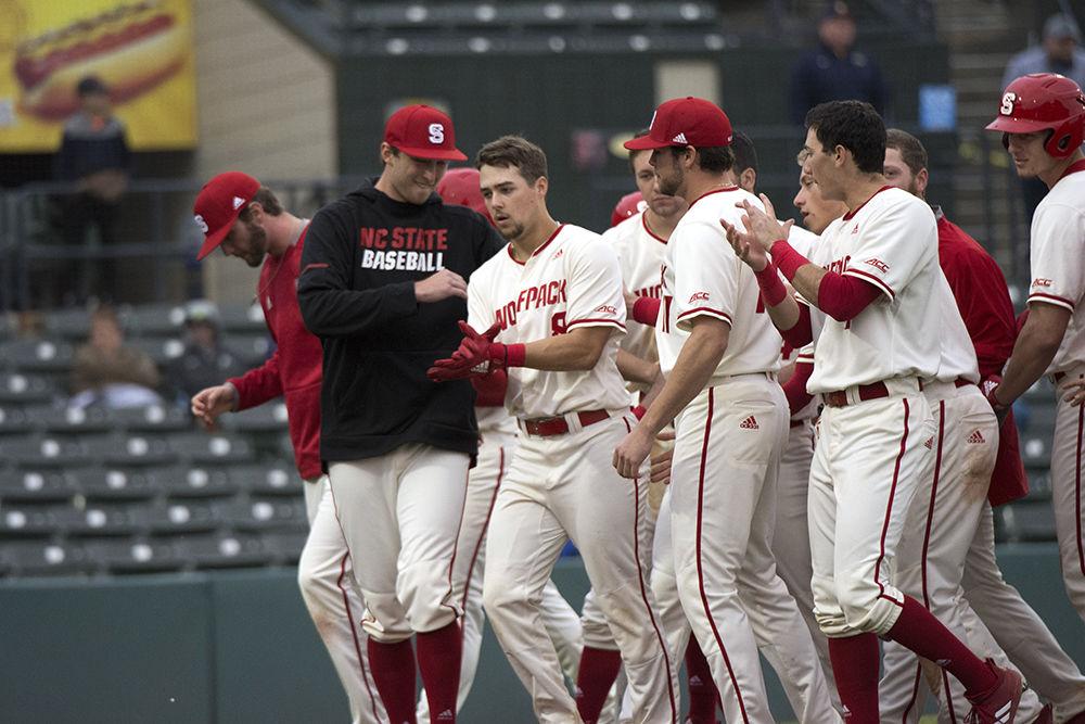 Junior shortstop Will Wilson is congratulated by the team after hitting a homerun to tie up the game in the eighth inning at Myrtle Beach Pelicans TICKETRETURN.COM Field, Friday, Feb. 22. The Wolfpack won in the eleventh inning, 3-2.&#160;