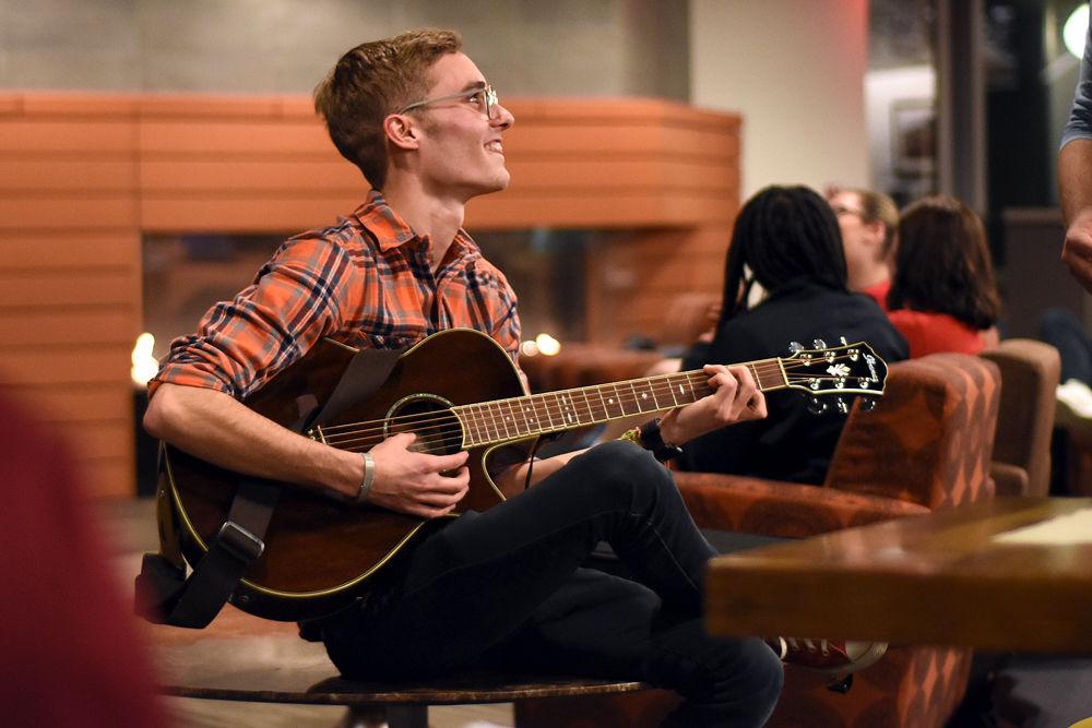 Timothy Boushell, a second-year studying computer and electrical engineering, socializes with other students before UAB's Chords and Coffee event in the One Earth Lounge on Wednesday, Feb. 6. Chords and Coffee invites anyone to perform and includes free coffee and tea.