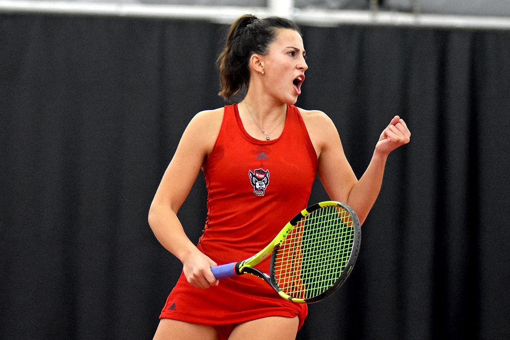 Senior Bianca Moldovan celebrates after a point for the Wolfpack during her doubles match with teammate Liz Norman. The duo lost the match against UNC-Chapel Hill 6-4 on Wednesday, Feb. 27 at J.W. Isenhour Tennis Center.