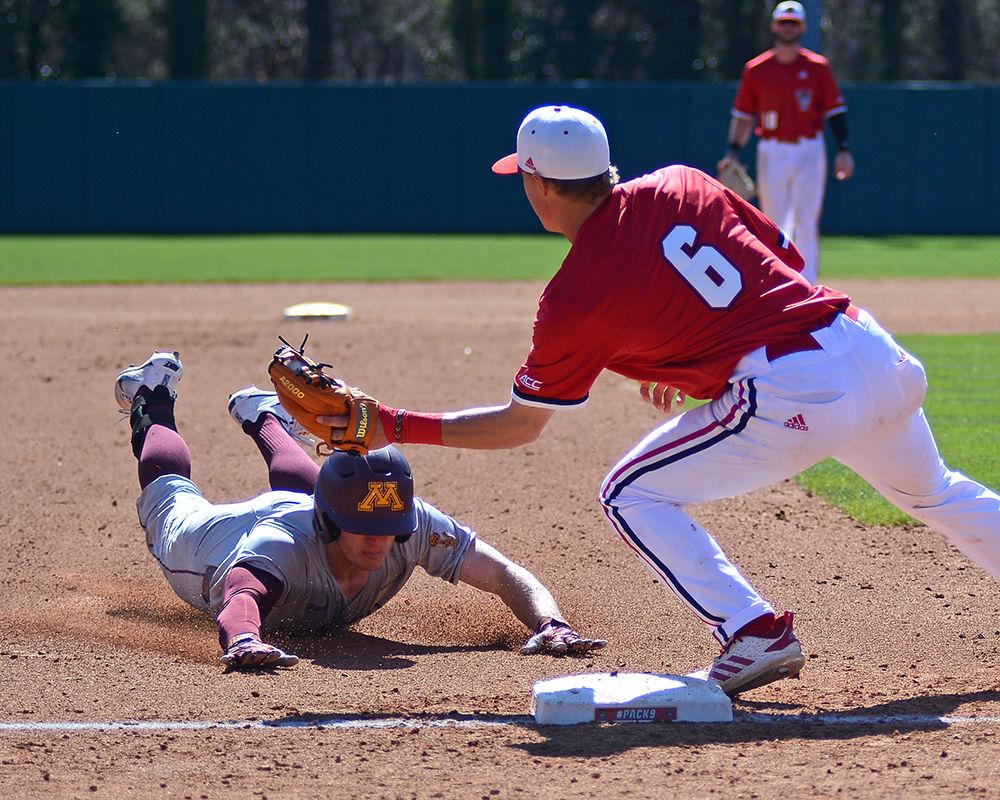 Freshman infielder Vojtech Mensik tags a Minnesota player during the first game of the doubleheader on Saturday, March 2, 2019, in Doak Field. The Wolfpack beat the Gophers 3-2, with Mensik going 1-2 with one strikeout, one run scored and one stolen base.