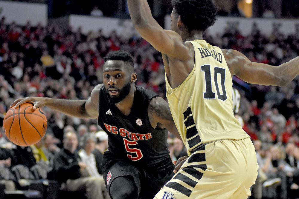 Graduate guard Eric Lockett dribbles against Wake Forest on Tuesday, Jan. 15 in Lawrence Joel Veterans Memorial Coliseum. Despite coming back from a 22-point deficit, the Wolfpack still ended up losing to the Demon Deacons 71-67.