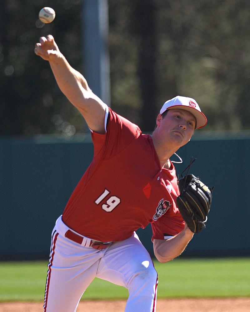 Redshirt sophomore pitcher Dalton Feeney throws the ball during the game against Minnesota on Saturday, March 2, at Doak Field. The Wolfpack won 3-2.