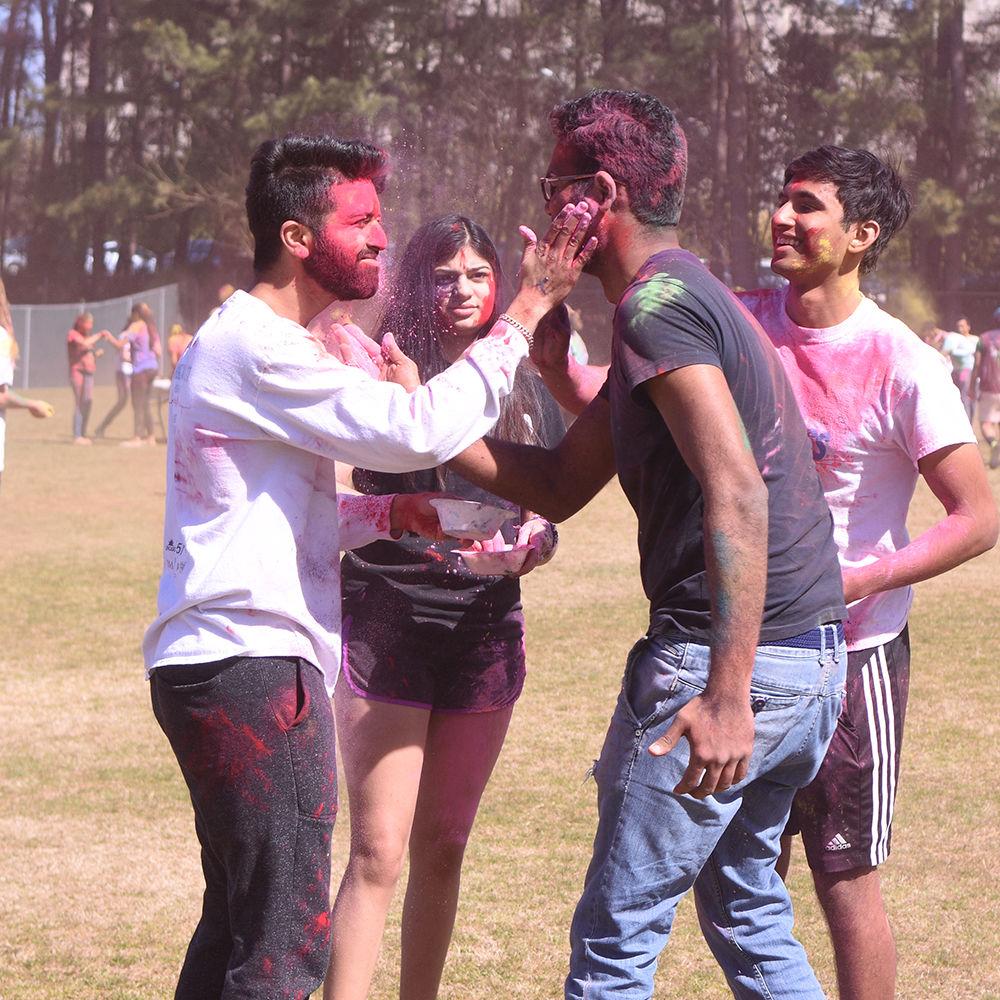 Third-year Alay Deliwala and graduate student Kushal Mandhani, both computer science majors, smear each other with powders at Holi on Sunday, March 24, 2019 in Lee Field. The events was hosted by MAITRI along with Ektaa and DSI.