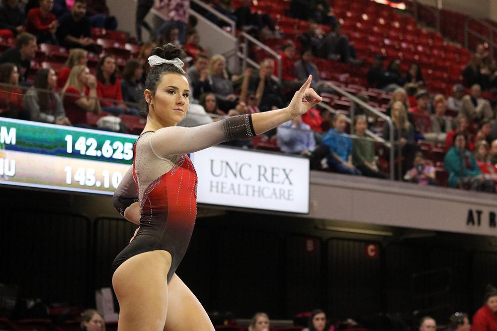 Senior Caitlyn Fillard strikes a pose during her floor exercise on Friday, February 22. Caitlyn won best all around at the tri-meet where NC State took home first place amongst William and Mary, and Western Michigan.